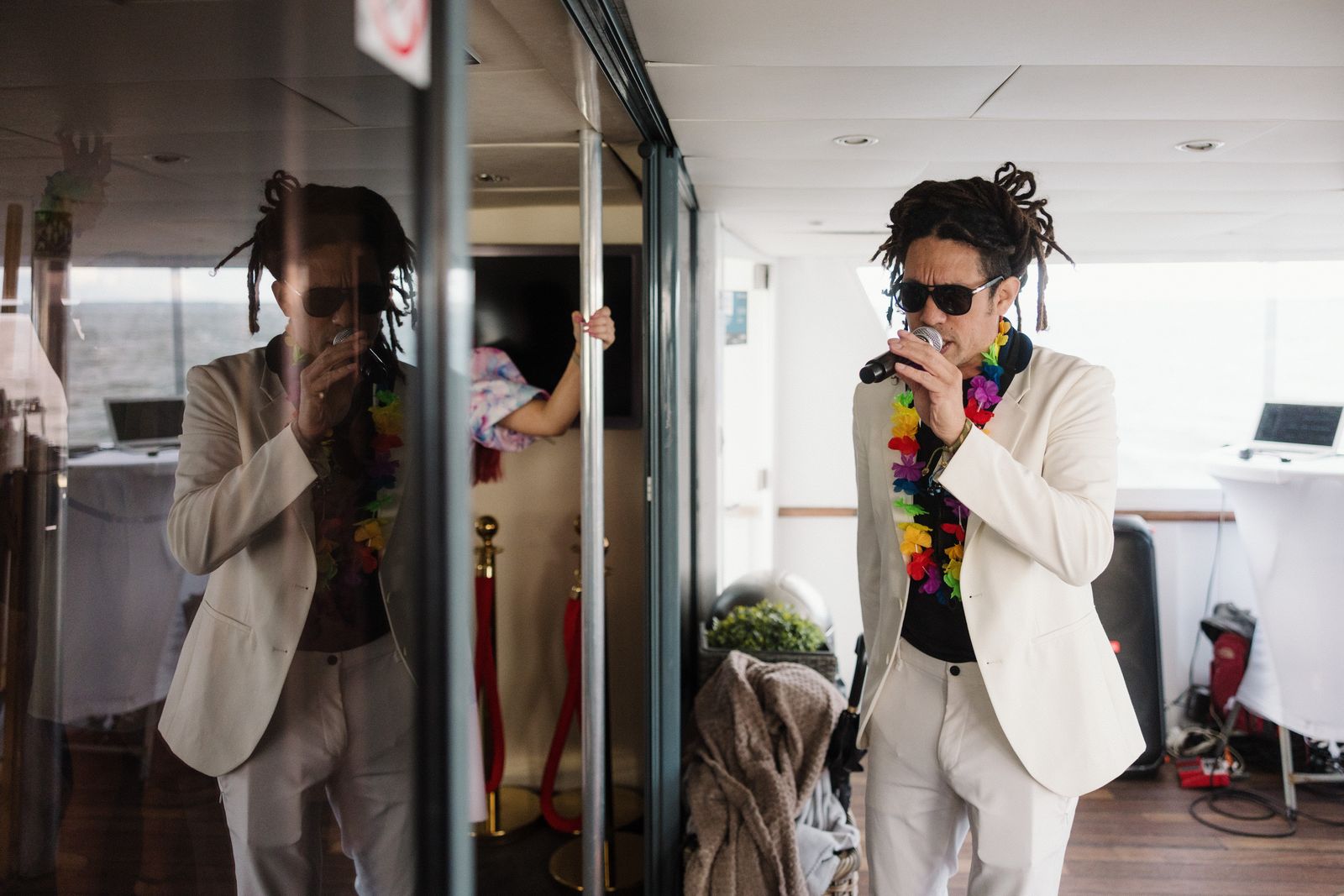 Singing in a white suit next to his reflection