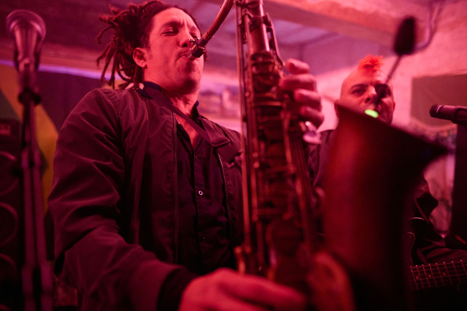 Playing saxophone under pink lights